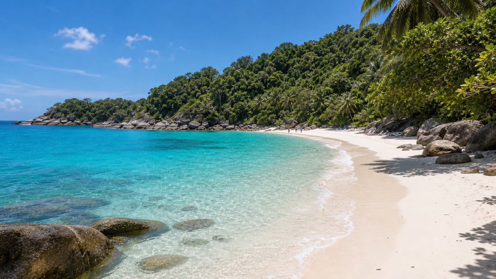 Clear water and rocky beach edge suitable for light snorkeling in Phuket